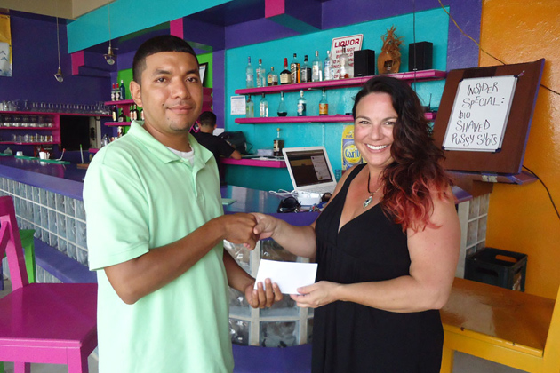 Brandy DeAngelo presents donations to Rene Riverol, Vice Chair of the NAC Island Committee National AIDS Commission Held Health Fair in Caye Caulker