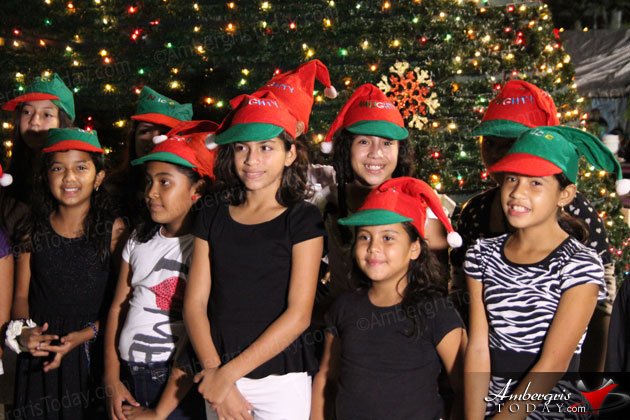With a very short ceremony headed by Mayor Daniel Guerrero, a giant Christmas Tree was lit at Central Park last night, Tuesday, December 3, 2014, to help bring in the holiday season to San Pedro, Ambergris Caye, Belize.   Together with Santa Claus taking pictures with the children and the Roman Catholic Church Choir showcasing Christmas Carols, Mayor Daniel Guerrero hit the switch that brought the Christmas Tree to life in downtown San Pedro, Central Park.  Everybody took out their cameras to take pictures by the tree and the San Pedro Town Council distributed cupcakes and soft drinks to all the children present. The Christmas Tree is a gift to San Pedro Town by Lady Dixie Bowen and Family. 