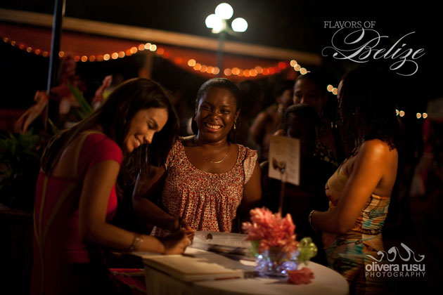 Flavors of Belie Cookbook publisher Tanya McNab signs some cookbooks at the launch event Flavors of Belize Cookbook
