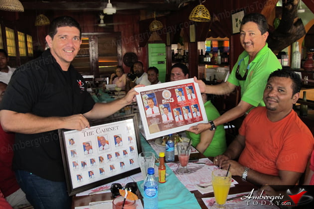 San Pedro Town Council Treats Media for Lunch 2 San Pedro Town Council Media Meeting -Mayor Danny Guerrero presents gift to Dorian Nunez of Ambergris Today