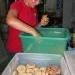 Angel Perlita packing the pastries in trays to be sold on the delivery tricycle.